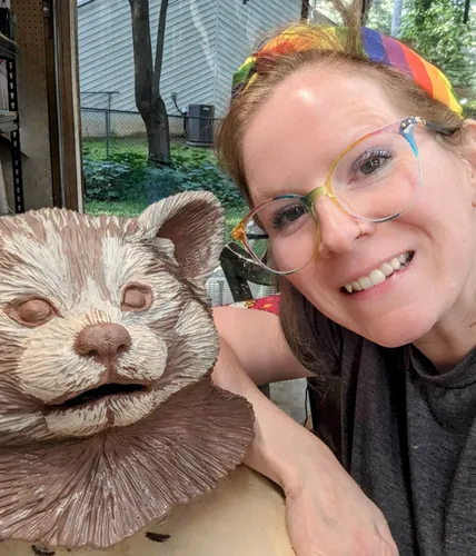 A red panda bust on the left and Kate on the right.